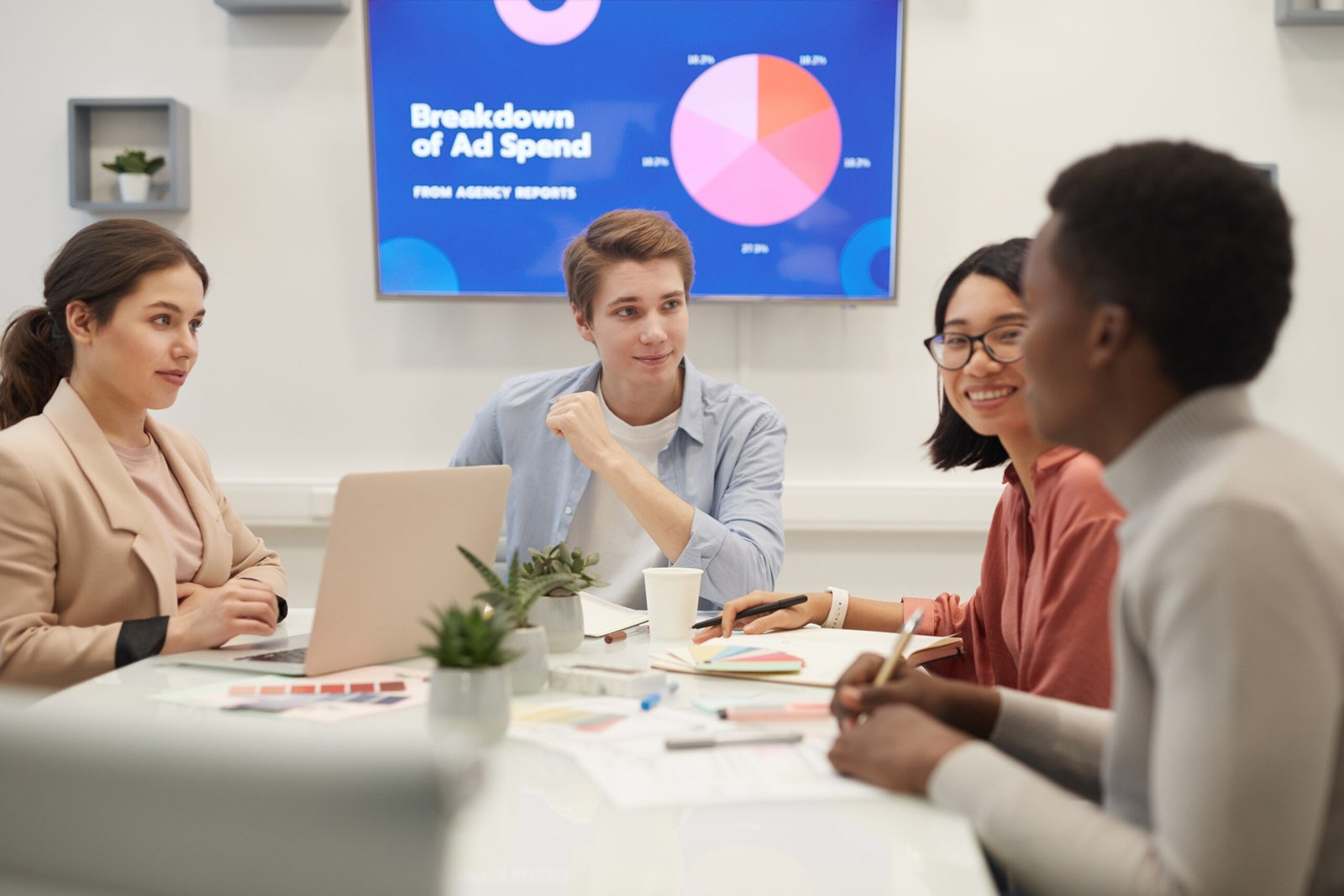 Young People Discussing Marketing in Meeting Ads Management
